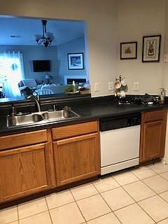 Tile floor kitchen w disposal and new refrigerator