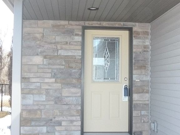 A covered entry opens into an..