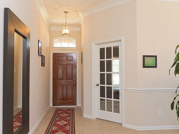 Elegant foyer w/tile & showing French doors leading to offic