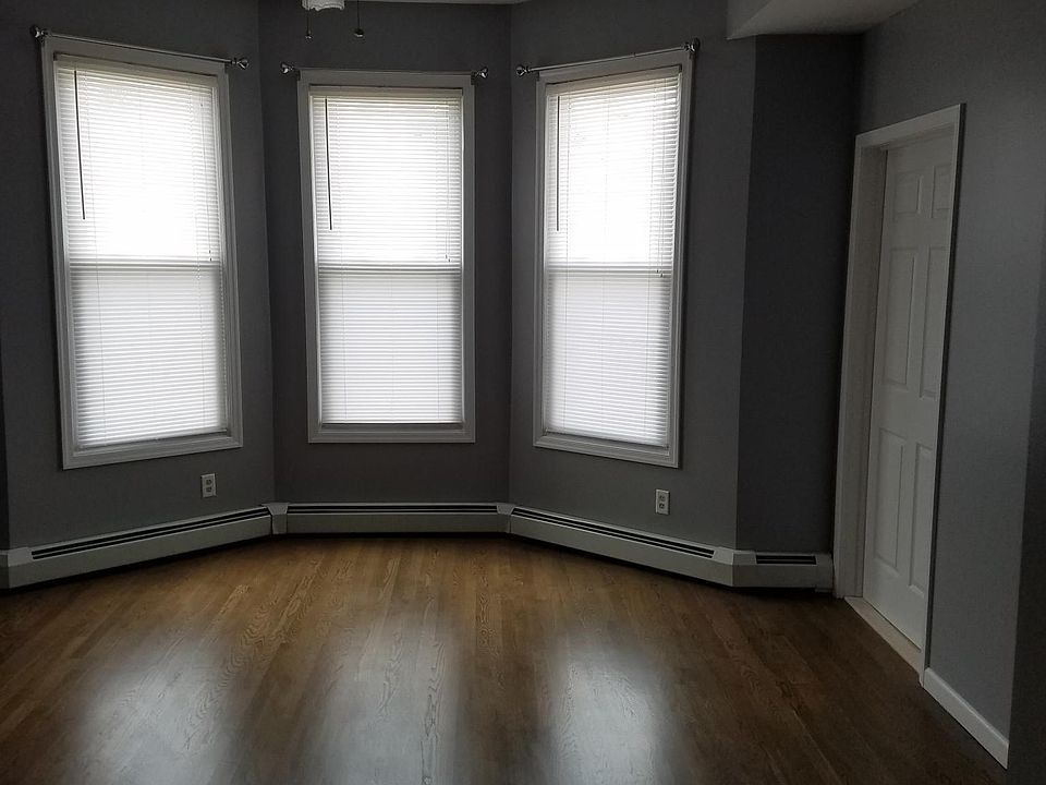 Large living room, door on right leads to in unit laundry room/storage