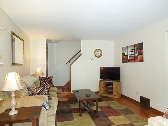 Inviting Living Room with gorgeous refinished HW floors - couch, love seat and wall fixtures included!!  All brand new