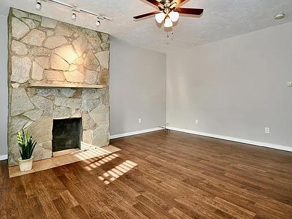 Living room, engineered wood floors, decorative fireplace, ceiling fan