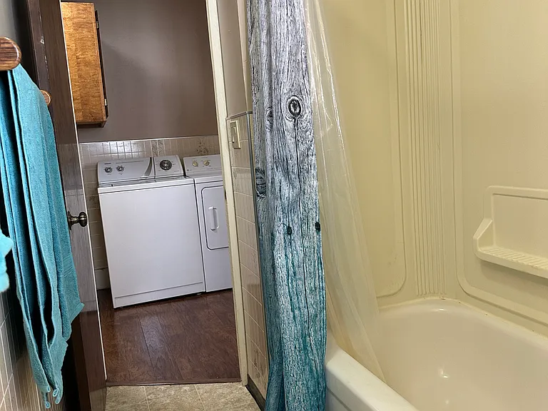View from far end of bathroom, looking toward the laundry alcove.