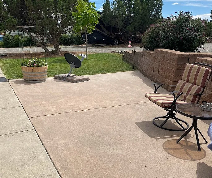 Back yard patio area with grass area.