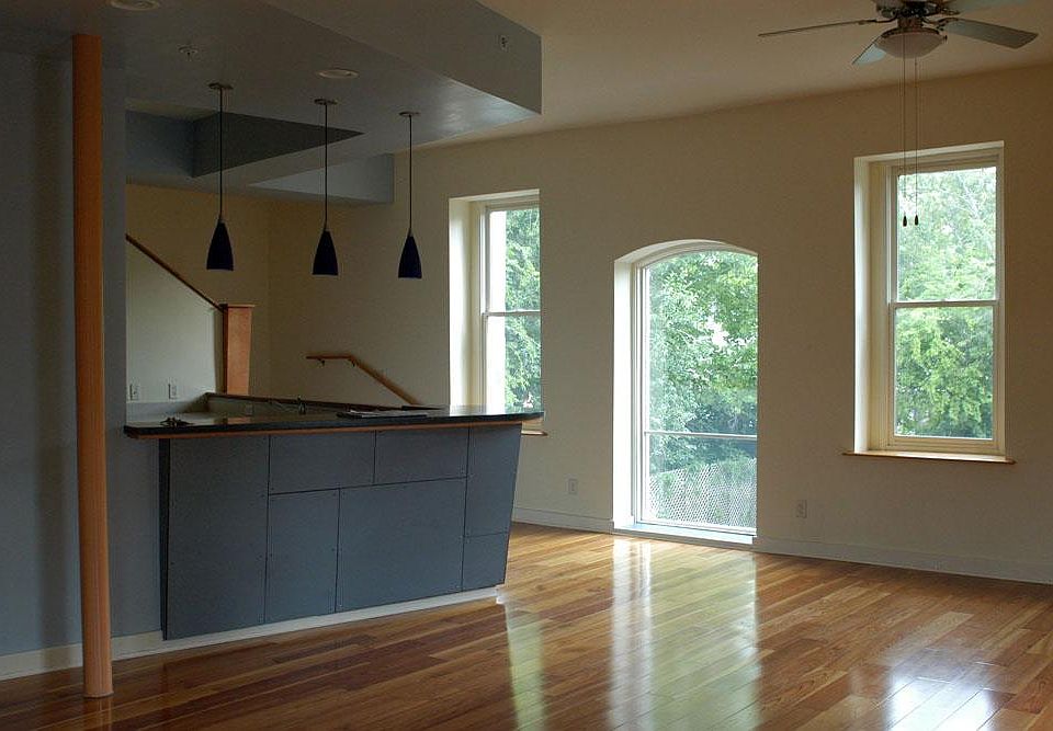 Open-plan living/dining area showing built-in breakfast bar off kitchen