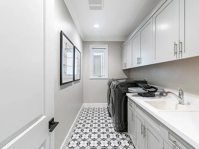 The upstairs laundry room is amazing! There's tons of storage, a sink and large counter for folding. The top of the line Samsung brand new Double washer and Double dryer are included! .... Love the flooring!
