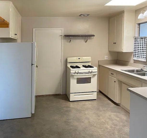 Kitchen with 30" gas stove and refrigerator. Note: There is a new stainless steel refrigerator in kitchen (white one is no longer there)