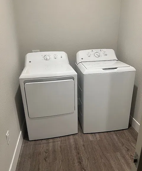 In unit full size washer and dryer with a full laundry room with space for shelves and storage.