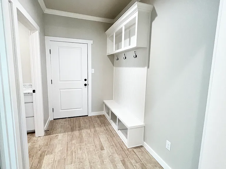 Hallway coming in from the garage with a built-in locker