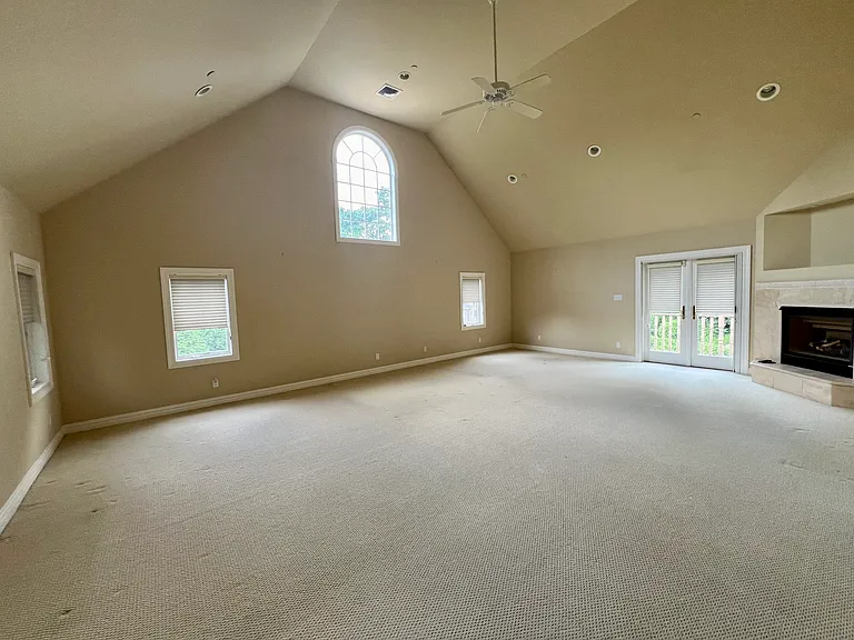 Primary bedroom with a fireplace and terrace