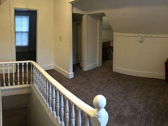 Entry/Common area. View is from entry door. Ahead and left are bedroom 1 & 2. Ahead is a small coat closet. Ahead and right is the living room and kitchen. Below and left is a stairway that serves only as a fire exit. To left is bathroom and bedroom
