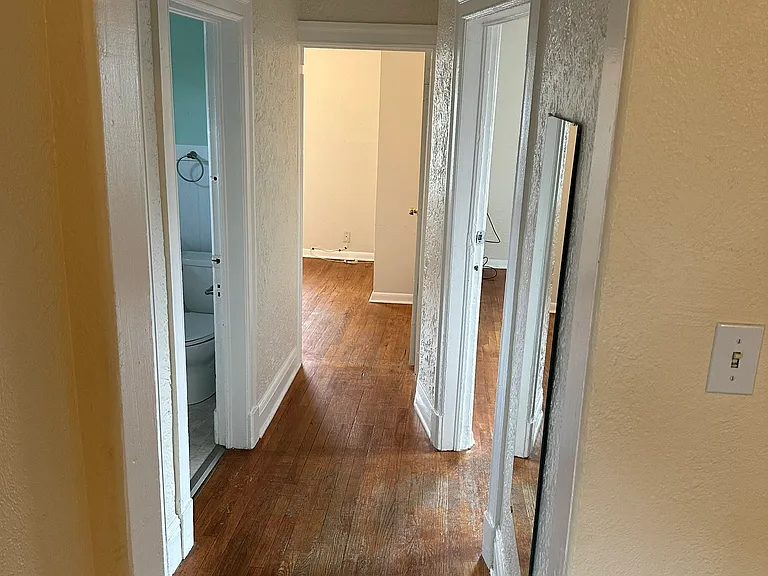 Hallway with original hardwoods throughout.