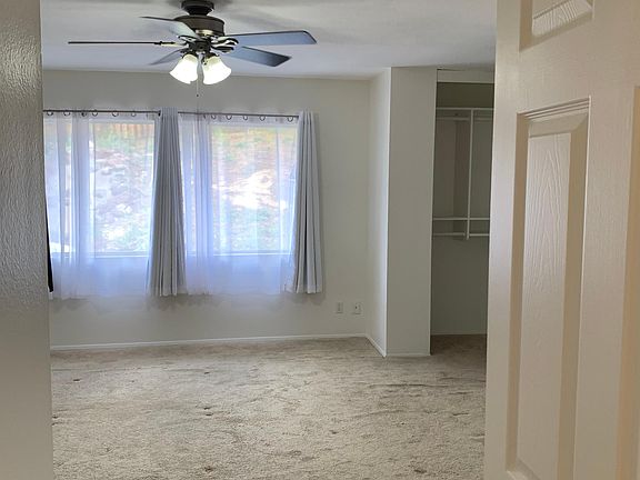 large master bedroom with windows to the backyard