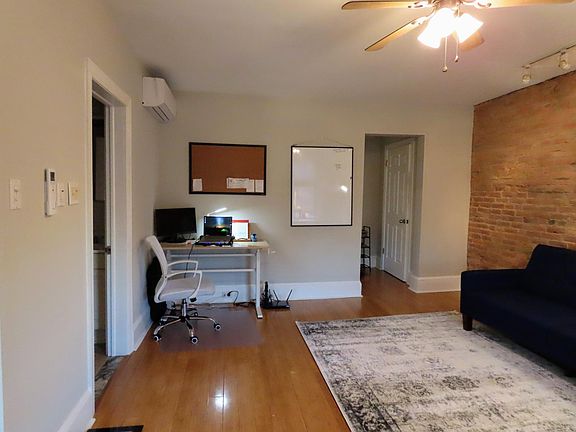 You can use my bulletin board and a 3'x4' whiteboard. And there's a mini-split here, so you can stay cool and warm regardless of the weather. As you can see, the desk has a handle on the right side. It's a height-adjustable desk, and you can use it as a s