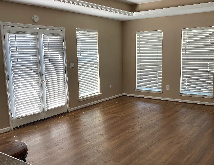 Open living room off kitchen with French doors onto deck