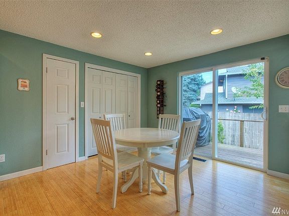 Kitchen nook with sliding glass doors leading out to the side deck. Don't miss the pantry or high efficiency washer & dryer.