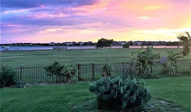 This photo was taken in 2017 (prior to current owner's purchase) showing lake view from backyard at sunset
