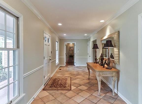 Picture windows in the foyer making it so bright, crown molding. A look down the hall to the bedrooms