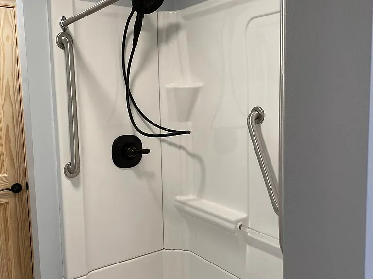 Bathroom with step in shower and rain forest shower head.