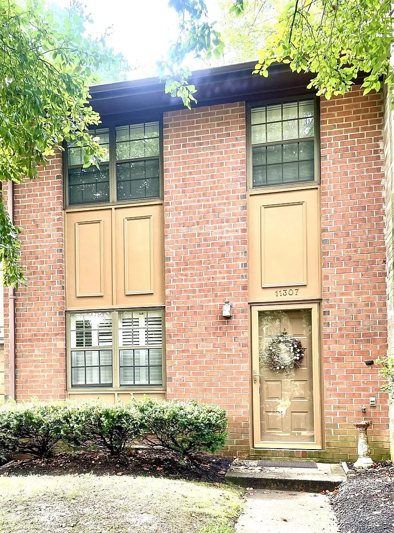 Charming Townhome with Distinct Living Spaces & Serene Tree-Lined Setting — Photo 1