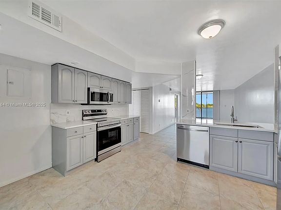 Open kitchen with view of lake. 
All new stainless steel appliances, new fixtures, countertops and backsplash.