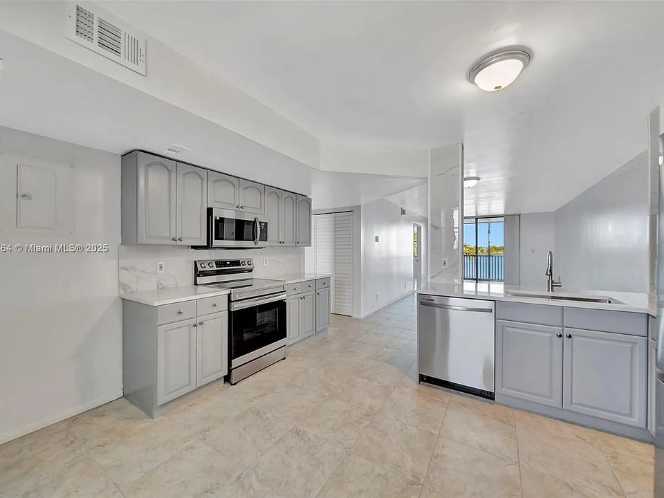 Open kitchen with view of lake. 
All new stainless steel appliances, new fixtures, countertops and backsplash.