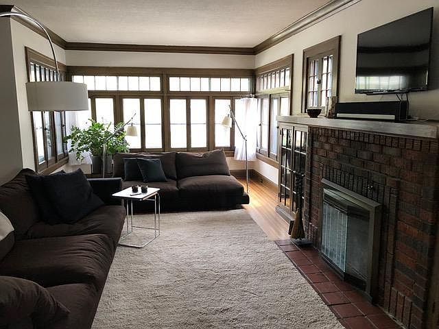 Beautiful living room with hardwood floors, built in bookshelves, fireplace, bump-out sunroom and lots of natural light.

furniture in photos is from a previous tenant