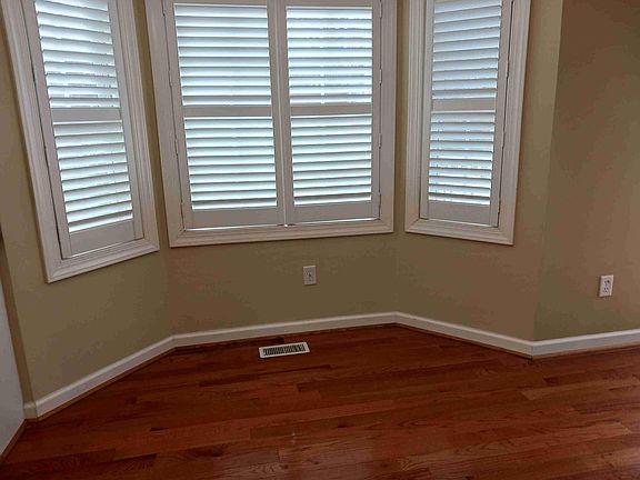 Kitchen eat in area with plantation shutters and beautiful hardwood floors