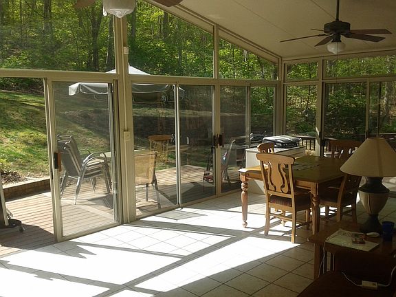 Sunroom with view of woods