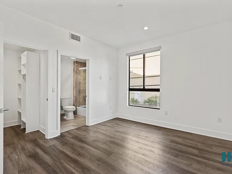 Bedroom with Bathroom, Vinyl Flooring, and Windows