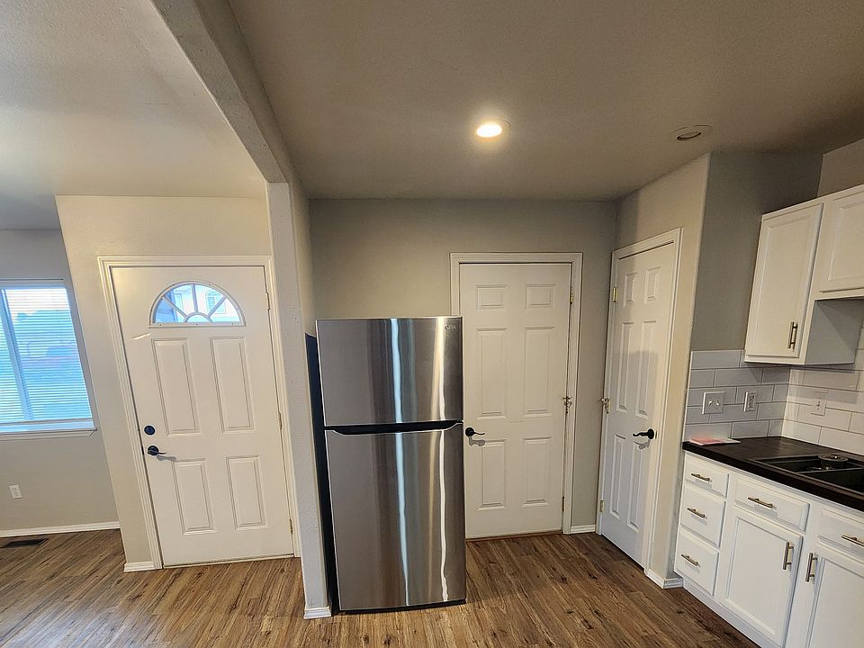 View is from hallway to kitchen, with front door on left and garage door on right