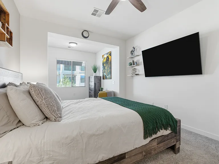 Spacious primary suite with plush bedding and thoughtful touches.