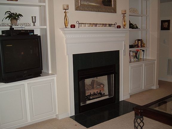 Living room with gas fireplace and vaulted ceiling