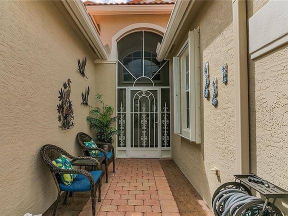 What a beautiful entrance to your new home!  Full accordion storm shutters for peace of mind.