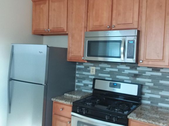 Kitchen w/ stainless range and microwave