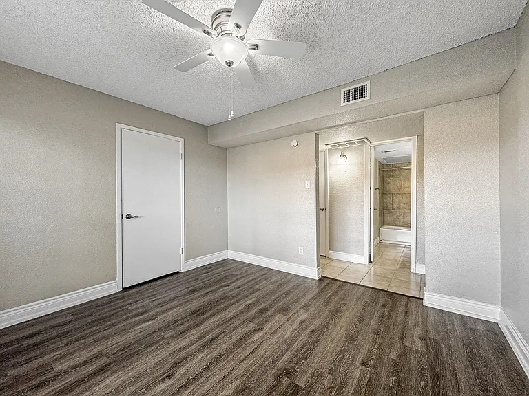 Spacious bedroom with attached bathroom at Borders Apartments Brownsville TX.