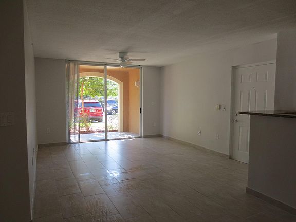Ground floor entrance with patio view. Total NEW flooring th