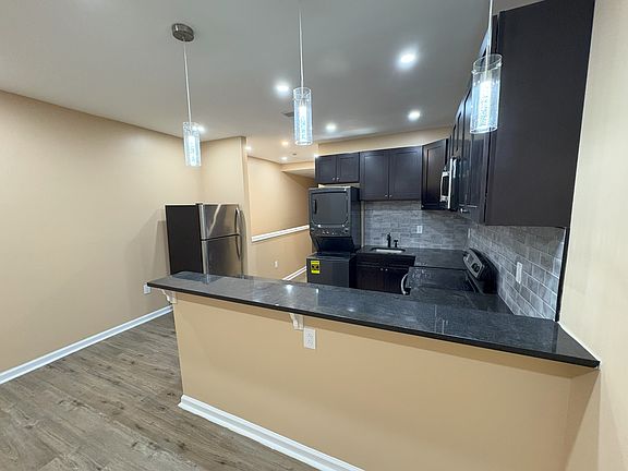 Open kitchen concept with recess lighting and over-the-bar spot lights.