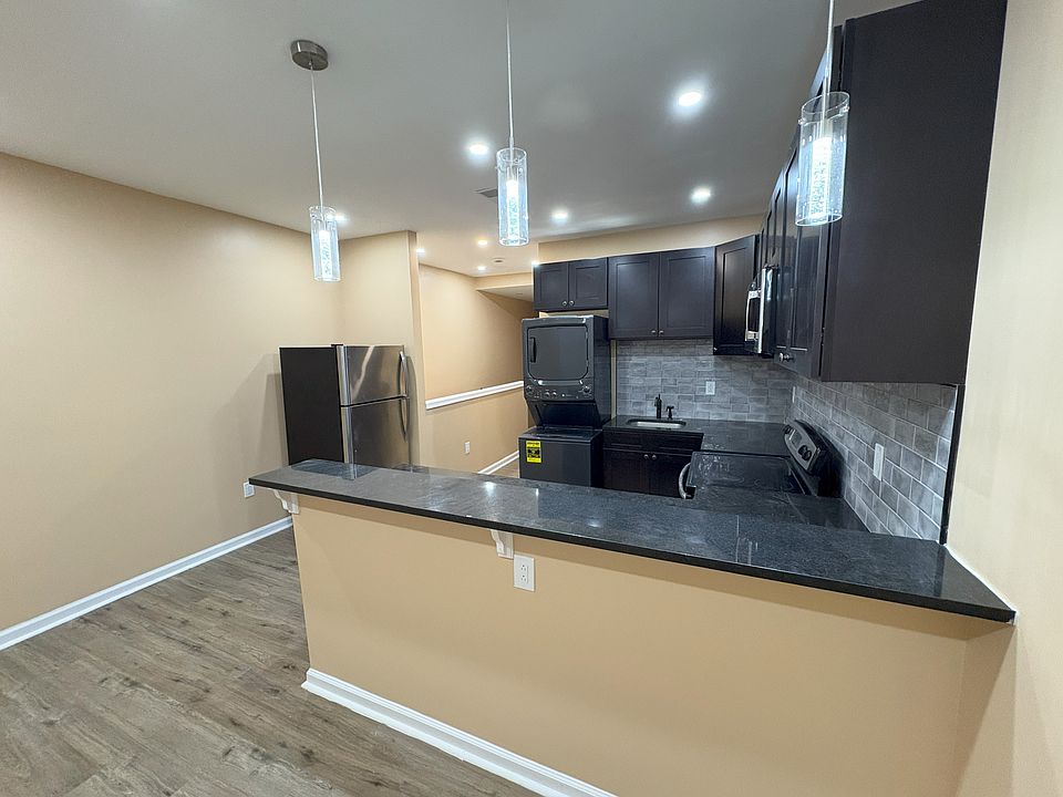 Open kitchen concept with recess lighting and over-the-bar spot lights.
