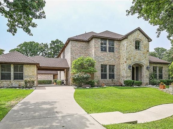 This stunning estate features multiple driveways with a porte-cochere & additional parking