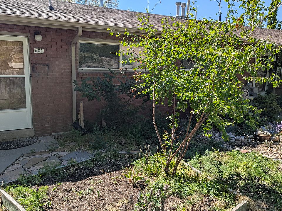 Apartment entrance with front yard and off-street parking