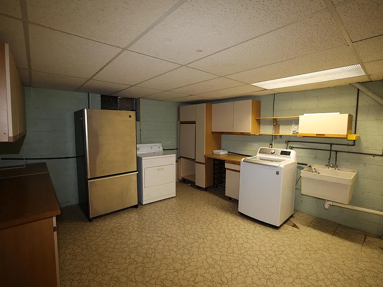 Laundry room, lots of storage, and an extra full size refrigerator