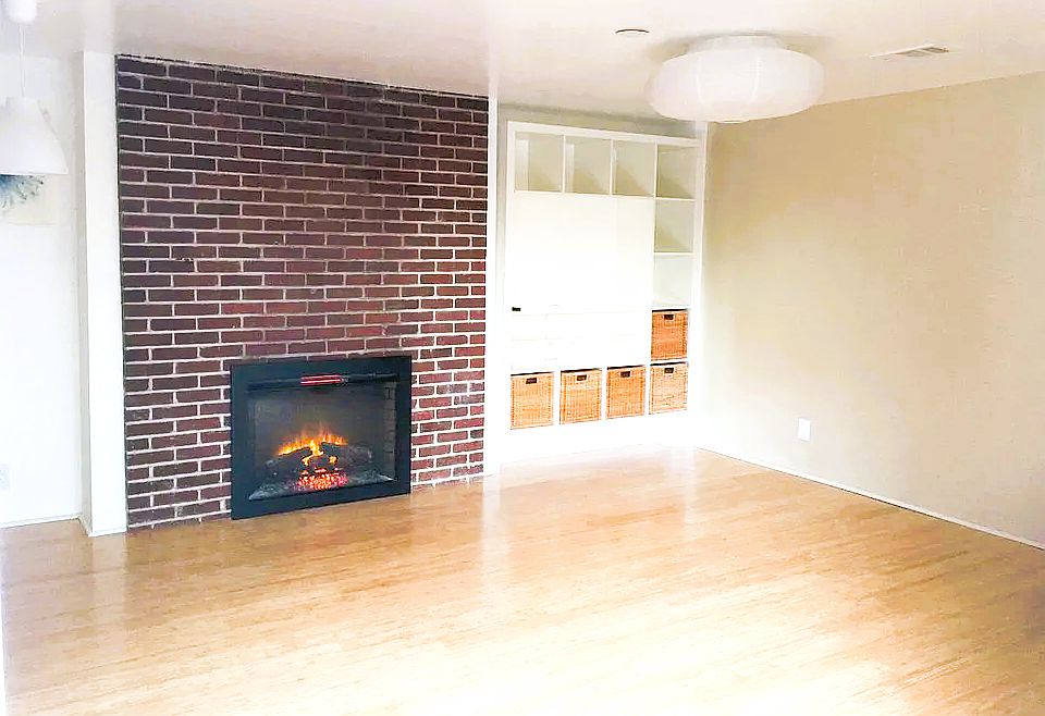 Living room with a fireplace and build in media console