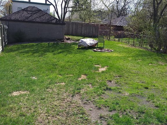 Back fenced-in yard and storage garage