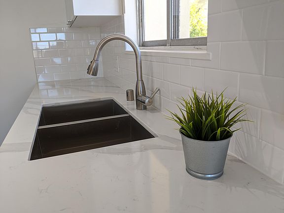 Kitchen with high-end designer quartz and stainless steel sink