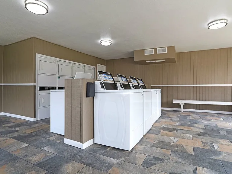 On-site laundry room with multiple washers and dryers for resident convenience.