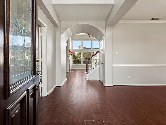 What a gorgeous entryway. The wood laminate floors are a perfect contrast to the fresh grey paint throughout the home.