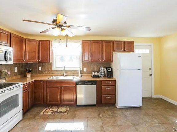 Bright pristine  kitchen opens to  private back yard