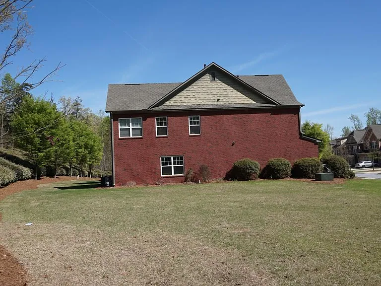 View from lovely yard to full brick side