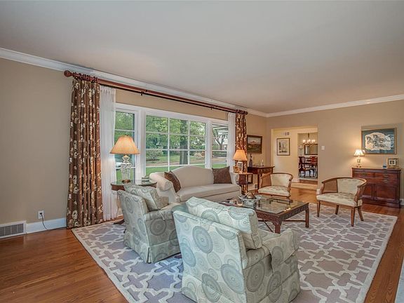 Big windows provide a picturesque view of the front yard.